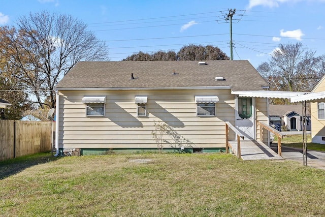 back of house with a lawn