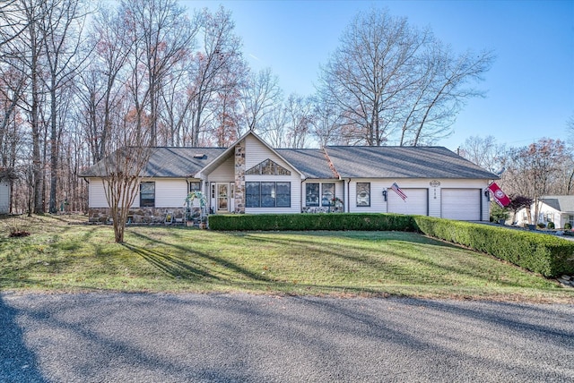 single story home with a garage and a front lawn