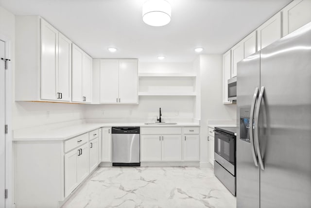 kitchen with sink, white cabinets, and appliances with stainless steel finishes