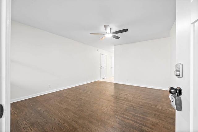 spare room with ceiling fan and dark wood-type flooring