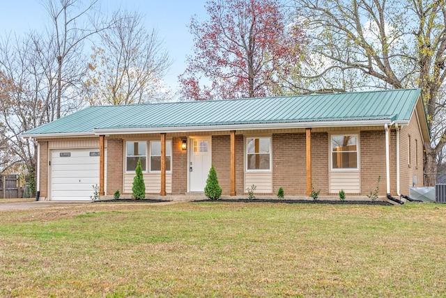 ranch-style house featuring a garage and a front lawn