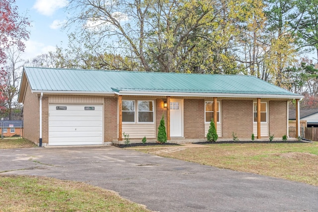 single story home with a garage and a front yard