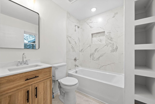 full bathroom featuring vanity, tiled shower / bath, and toilet