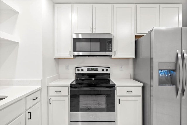 kitchen with white cabinets and appliances with stainless steel finishes