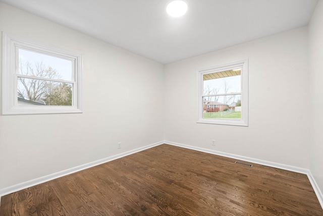 empty room with hardwood / wood-style flooring