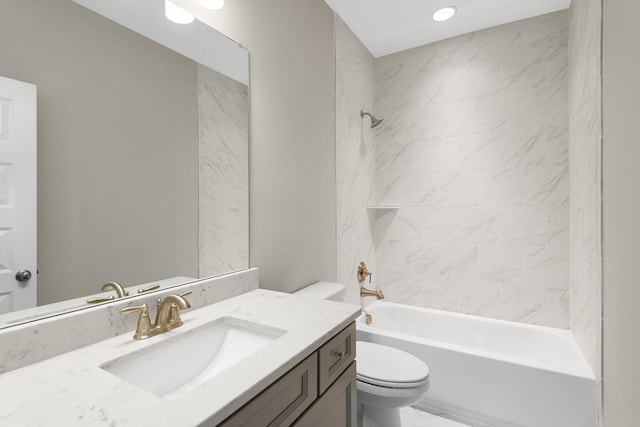 full bathroom featuring vanity, toilet, and tiled shower / bath