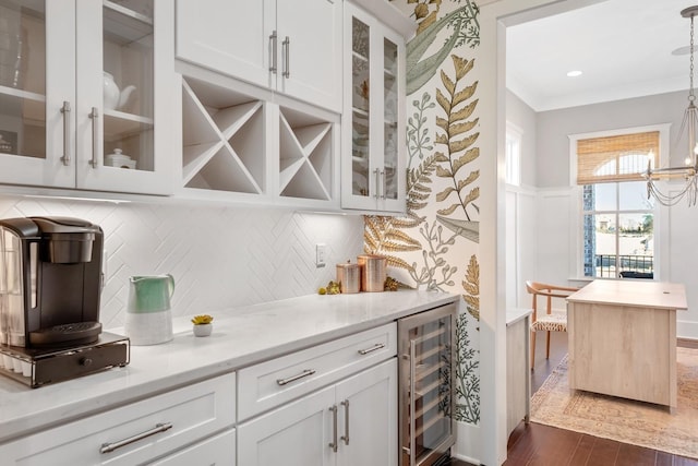 bar featuring white cabinets, dark hardwood / wood-style flooring, wine cooler, and hanging light fixtures