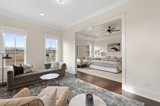 bedroom with dark hardwood / wood-style floors, ceiling fan, and crown molding