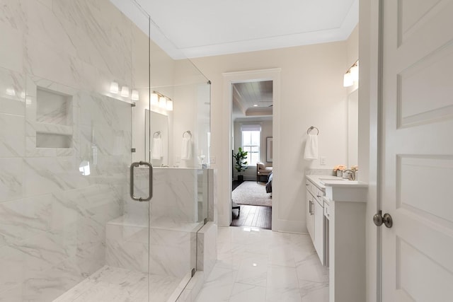 bathroom featuring crown molding, vanity, and a shower with shower door