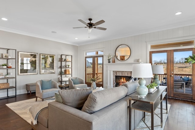 living room with french doors, dark hardwood / wood-style floors, ceiling fan, and crown molding