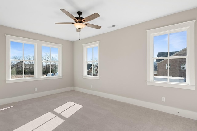 spare room with light carpet and ceiling fan