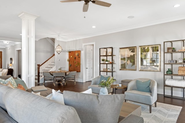 living room with dark hardwood / wood-style flooring, ornate columns, ceiling fan, and ornamental molding