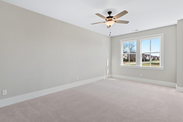 unfurnished room featuring ceiling fan and light carpet