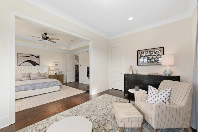 bedroom featuring a raised ceiling, ceiling fan, crown molding, and dark hardwood / wood-style floors