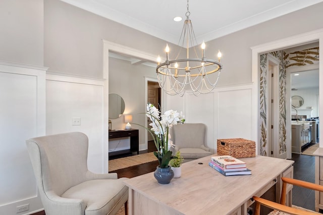 dining space with wood-type flooring, crown molding, and a notable chandelier