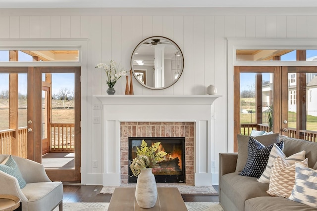 interior space featuring wooden walls, a fireplace, and dark hardwood / wood-style floors