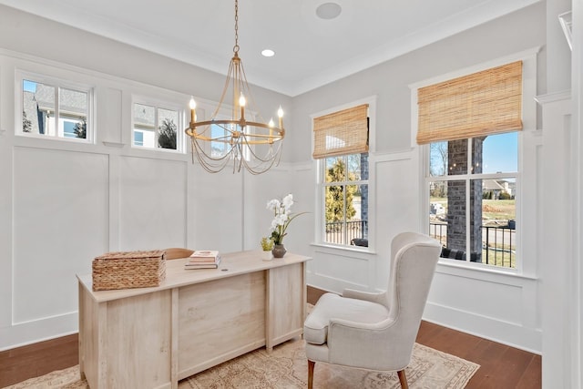 interior space featuring crown molding, plenty of natural light, a chandelier, and hardwood / wood-style flooring