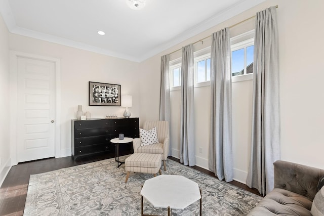 living area with crown molding and dark hardwood / wood-style flooring