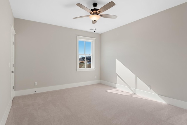 unfurnished room with ceiling fan and light colored carpet