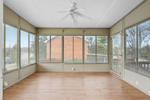 unfurnished sunroom with ceiling fan and plenty of natural light