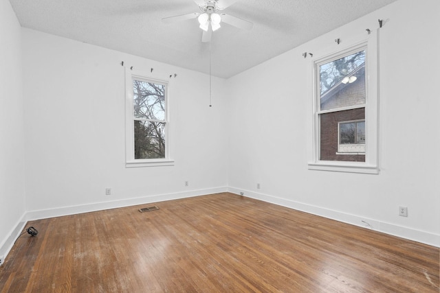 unfurnished room featuring ceiling fan, a textured ceiling, and hardwood / wood-style flooring