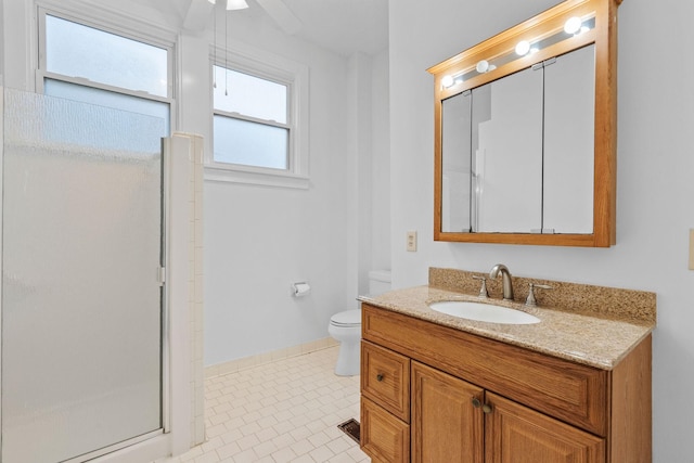 bathroom with toilet, vanity, tile patterned floors, and a shower with door