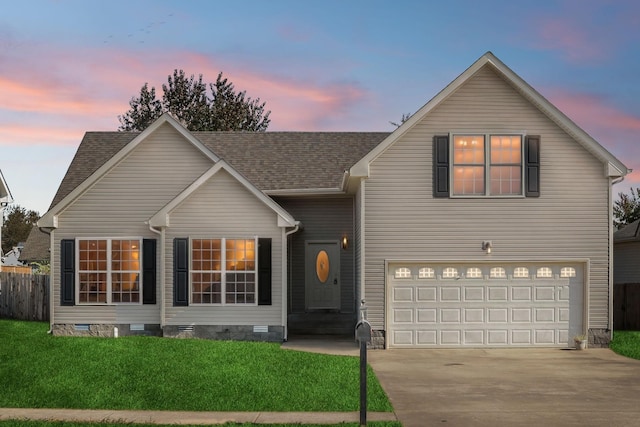 view of front of house featuring a yard and a garage