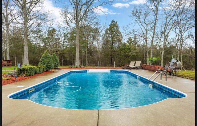 view of swimming pool featuring a patio area