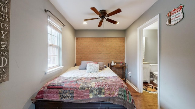 bedroom featuring ceiling fan, wood-type flooring, and ensuite bathroom