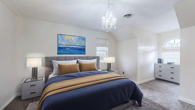 carpeted bedroom with a notable chandelier and lofted ceiling