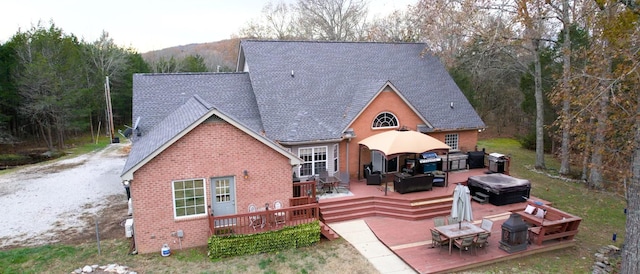 back of property with an outdoor hangout area, a jacuzzi, and a wooden deck