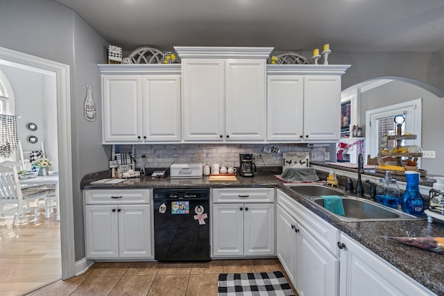 kitchen featuring white cabinetry, dishwasher, sink, backsplash, and light hardwood / wood-style floors