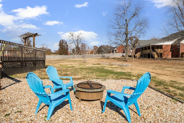 view of yard featuring an outdoor fire pit and a wooden deck