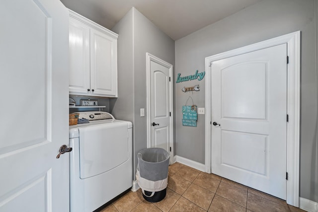 laundry area with cabinets, light tile patterned floors, and washer / clothes dryer