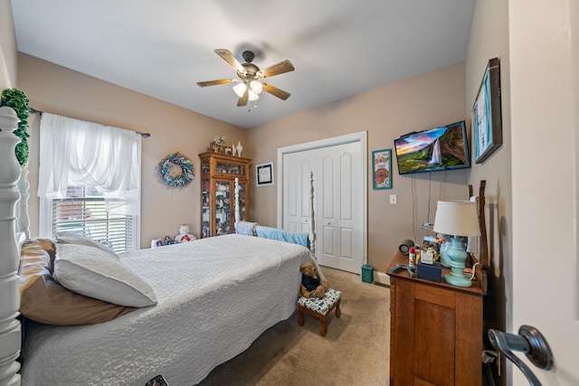 carpeted bedroom featuring ceiling fan and a closet