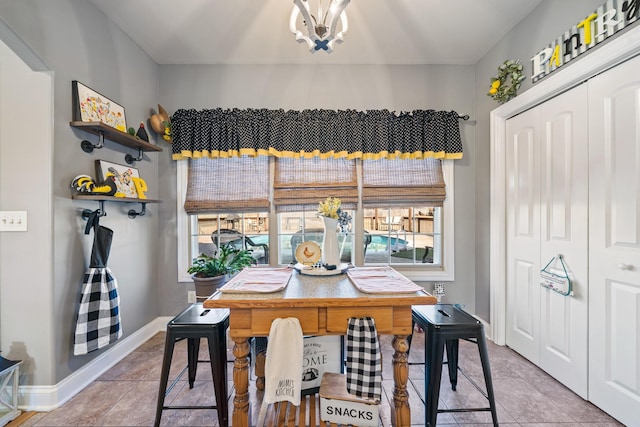 tiled dining area with a chandelier