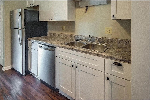 kitchen featuring sink, white cabinets, stainless steel appliances, and dark hardwood / wood-style floors