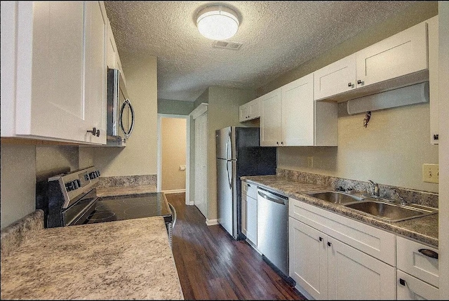 kitchen featuring white cabinetry, sink, appliances with stainless steel finishes, and dark wood-type flooring