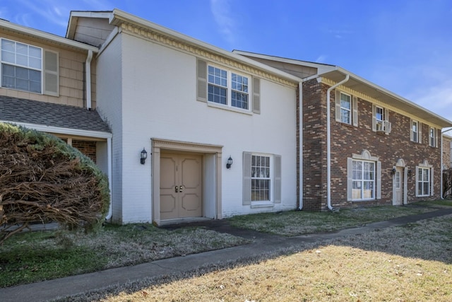 townhome / multi-family property featuring brick siding and cooling unit