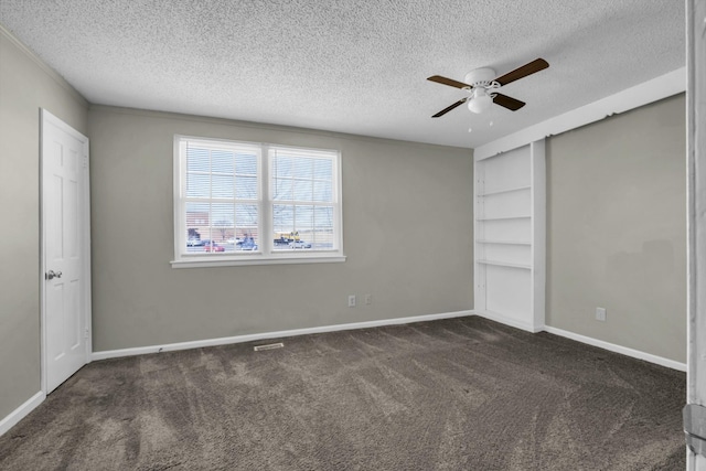 unfurnished bedroom with ceiling fan, carpet, baseboards, and a textured ceiling