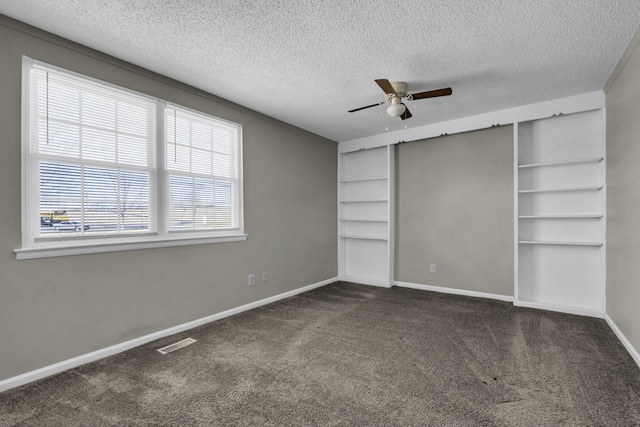 unfurnished bedroom with visible vents, ceiling fan, baseboards, carpet floors, and a textured ceiling