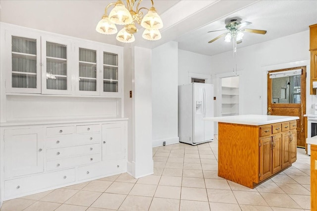 kitchen featuring a kitchen island, decorative light fixtures, white appliances, light tile patterned floors, and ceiling fan with notable chandelier