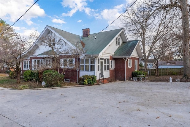 view of side of property featuring a sunroom