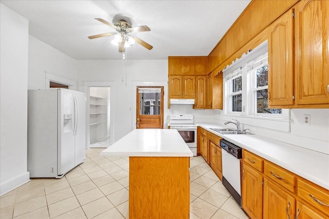 kitchen with ceiling fan, sink, light tile patterned floors, white appliances, and a kitchen island