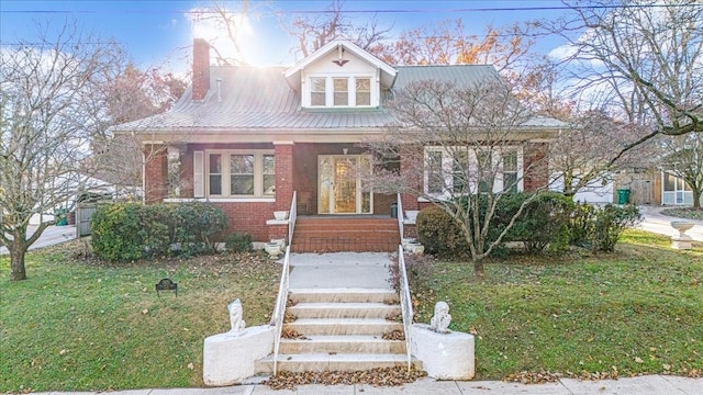 bungalow-style house featuring a front yard