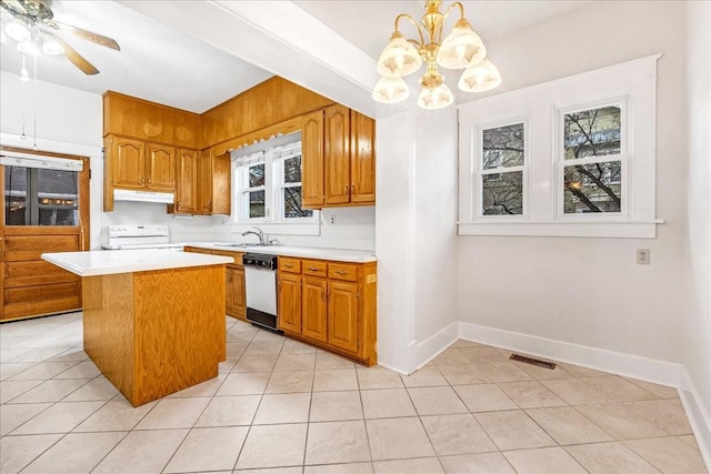 kitchen featuring pendant lighting, white appliances, a kitchen island, and a healthy amount of sunlight