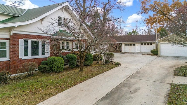 view of front of property with a garage and an outbuilding