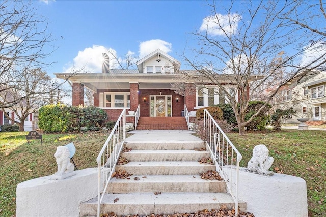 view of front of house featuring a front lawn and covered porch