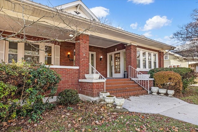 view of exterior entry featuring covered porch