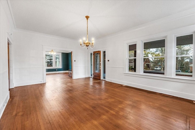 interior space featuring a textured ceiling, dark wood-type flooring, crown molding, and a notable chandelier